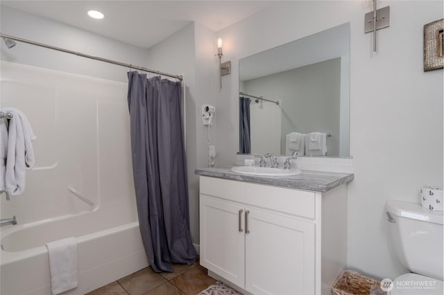 full bath featuring toilet, tile patterned flooring, shower / bath combination with curtain, and vanity