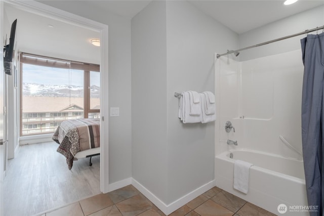 full bathroom with shower / bathtub combination with curtain, baseboards, and tile patterned flooring