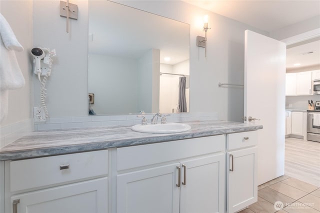 bathroom with tile patterned flooring, vanity, and a shower with curtain