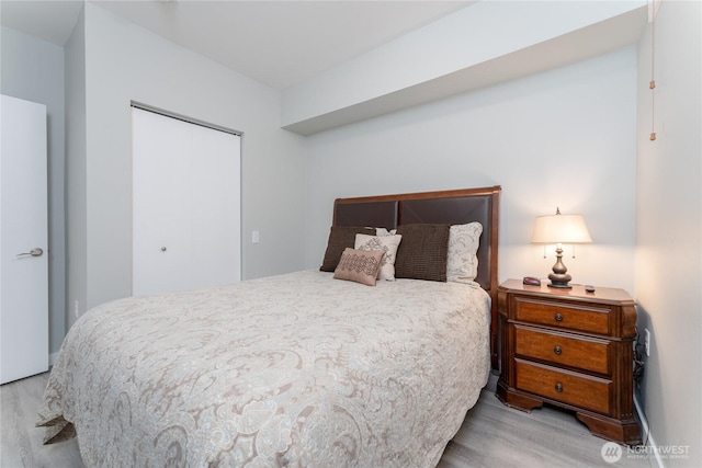 bedroom with a closet and wood finished floors