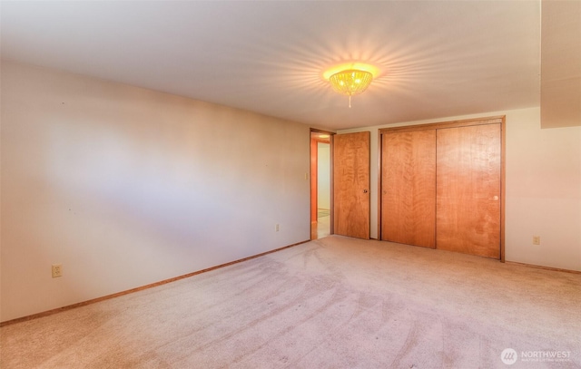 unfurnished bedroom with carpet and baseboards