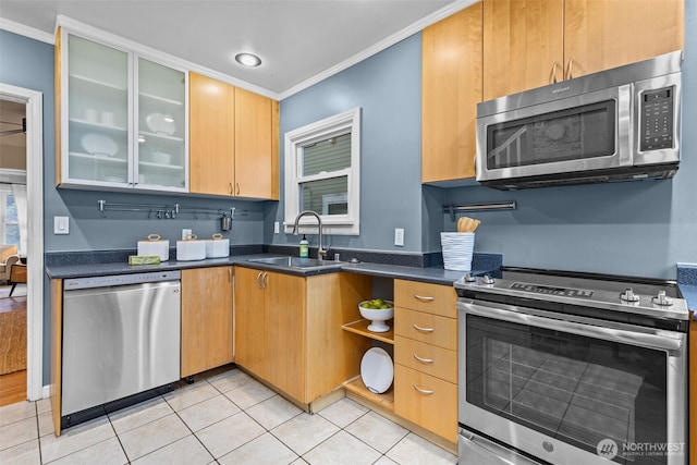 kitchen featuring light tile patterned flooring, stainless steel appliances, a sink, ornamental molding, and glass insert cabinets