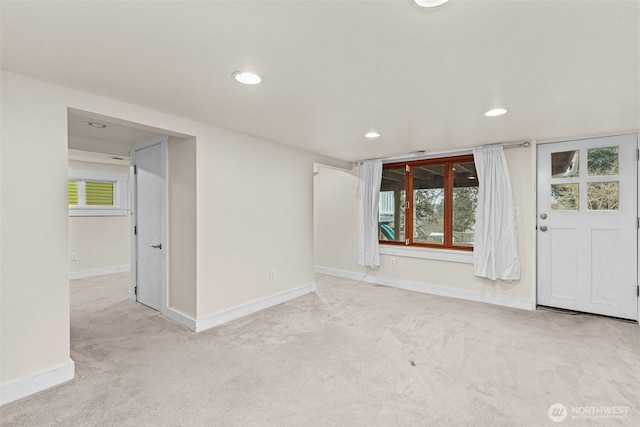 unfurnished room with light carpet, plenty of natural light, and baseboards