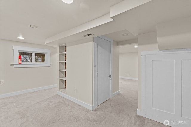 finished below grade area featuring light carpet, baseboards, visible vents, and recessed lighting