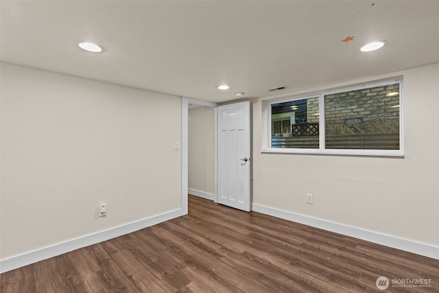 spare room featuring visible vents, baseboards, dark wood finished floors, and recessed lighting