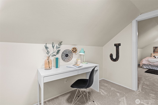 home office featuring light colored carpet, vaulted ceiling, and baseboards