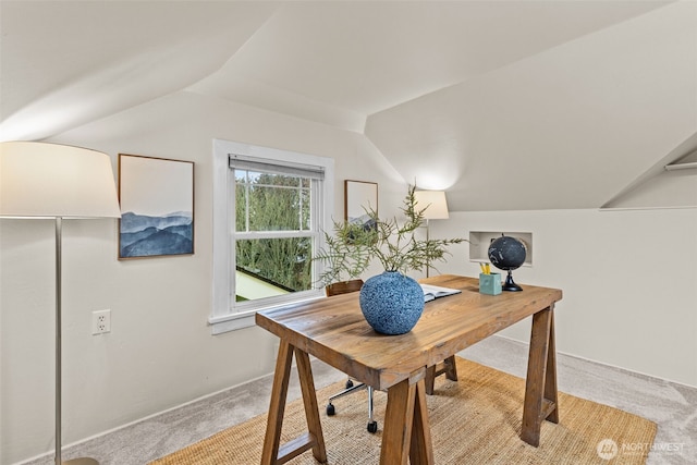 office space with vaulted ceiling and light colored carpet