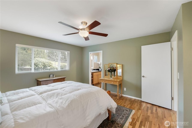 bedroom featuring baseboards, light wood-style floors, ensuite bathroom, and a ceiling fan