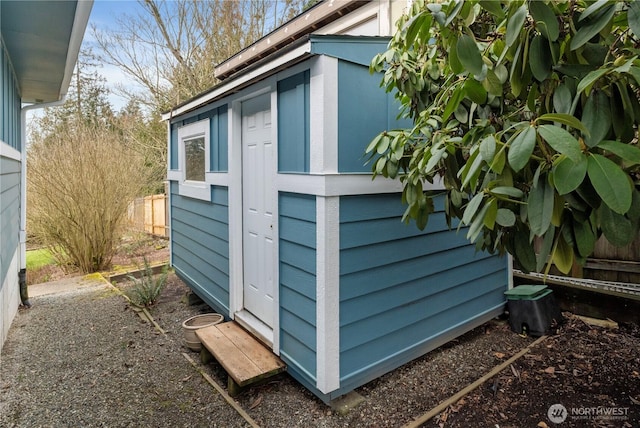 view of outbuilding with an outdoor structure and fence