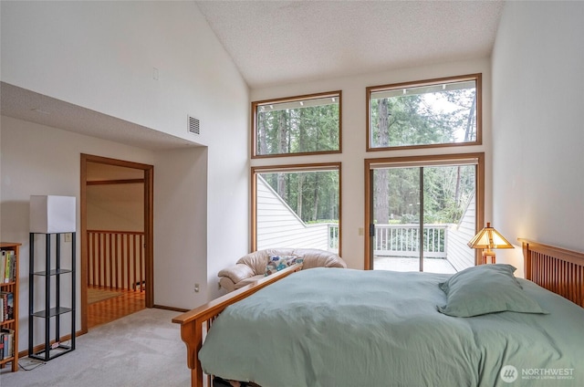 bedroom with a textured ceiling, high vaulted ceiling, light carpet, visible vents, and access to outside