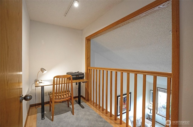 office featuring baseboards and a textured ceiling