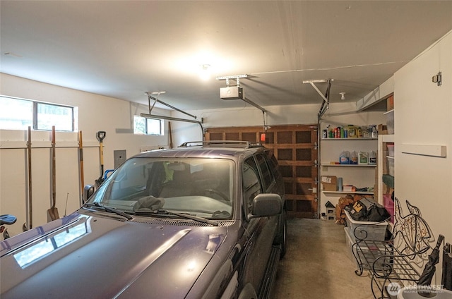 garage featuring a garage door opener and electric panel