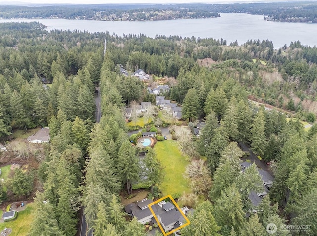 birds eye view of property with a water view and a forest view