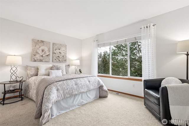 carpeted bedroom featuring visible vents and baseboards