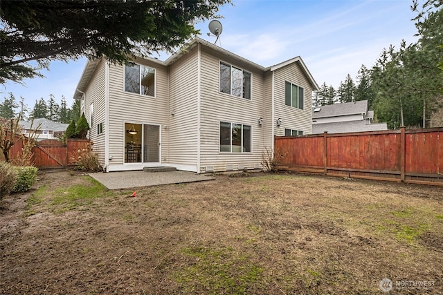 back of property with a patio area, a fenced backyard, and a lawn