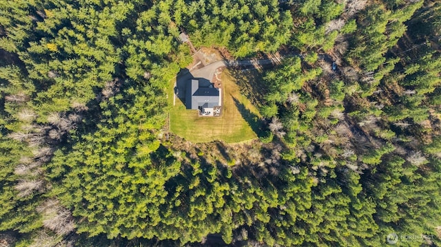 birds eye view of property featuring a view of trees