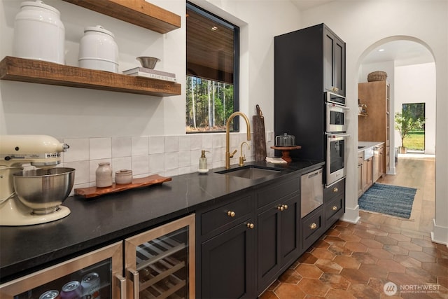 kitchen with a warming drawer, open shelves, backsplash, a sink, and beverage cooler