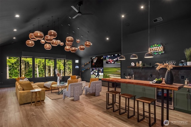 bar featuring beverage cooler, a dry bar, light wood-type flooring, and visible vents