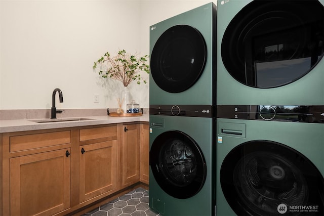 washroom with stacked washer / dryer, a sink, and cabinet space