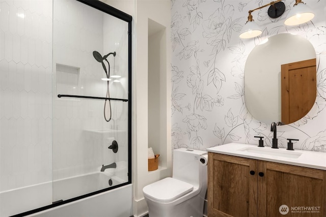 full bathroom with enclosed tub / shower combo, vanity, toilet, and wallpapered walls