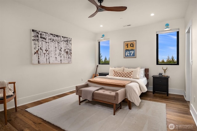 bedroom with recessed lighting, visible vents, baseboards, and wood finished floors