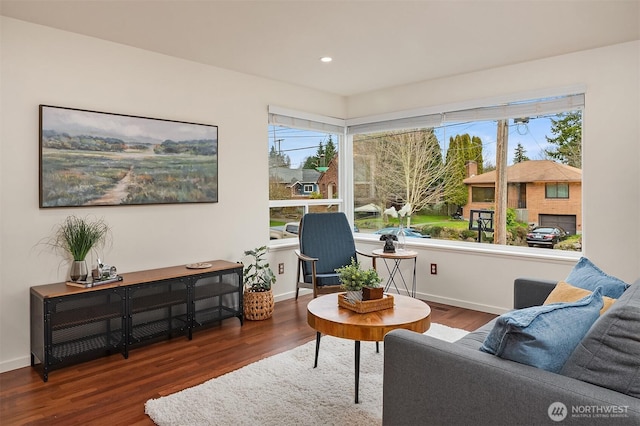 sitting room featuring baseboards, wood finished floors, and recessed lighting