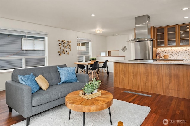 living area with dark wood-style floors and recessed lighting