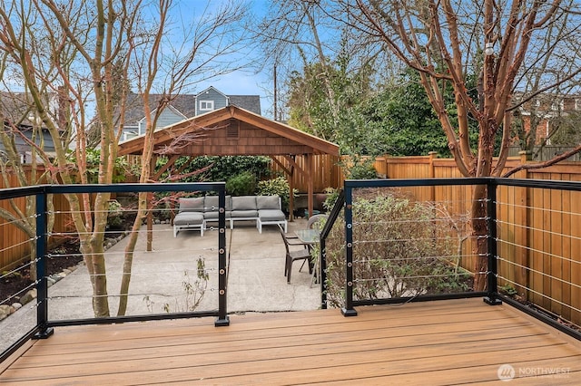 wooden deck featuring a fenced backyard and an outdoor living space