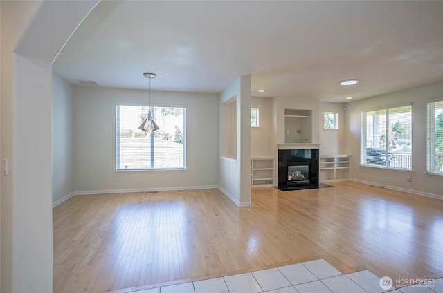 4329 Fairwood Blvd NE, Tacoma, WA 98422 - unfurnished living room featuring light wood-type flooring, baseboards, visible vents, and a healthy amount of sunlight