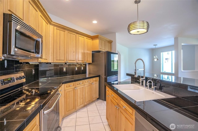 4329 Fairwood Blvd NE, Tacoma, WA 98422 - kitchen featuring a sink, decorative light fixtures, backsplash, appliances with stainless steel finishes, and light tile patterned floors