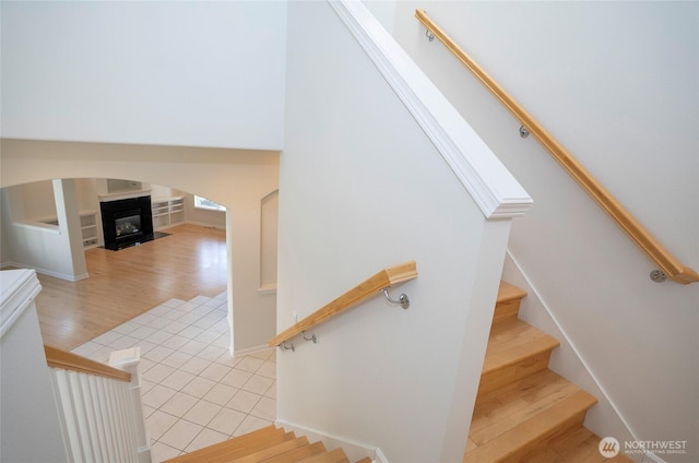 4329 Fairwood Blvd NE, Tacoma, WA 98422 - stairway with a glass covered fireplace and wood finished floors