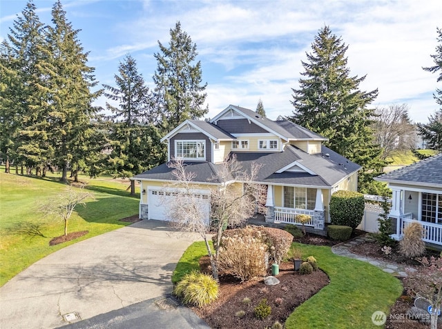 4329 Fairwood Blvd NE, Tacoma, WA 98422 - view of front facade featuring covered porch, concrete driveway, a front lawn, a garage, and stone siding