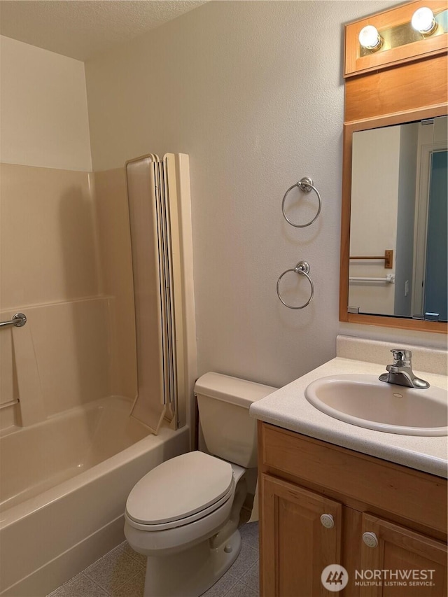 bathroom with toilet, tub / shower combination, and vanity