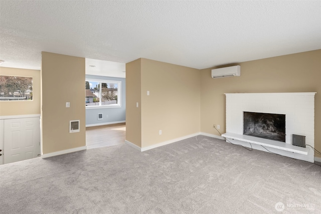 unfurnished living room featuring baseboards, visible vents, carpet floors, a wall mounted air conditioner, and a brick fireplace