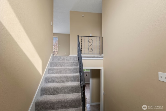 stairway featuring baseboards