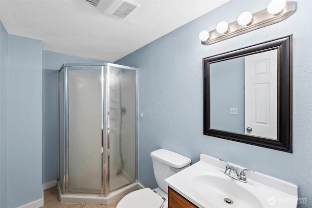 bathroom with visible vents, toilet, a stall shower, and vanity