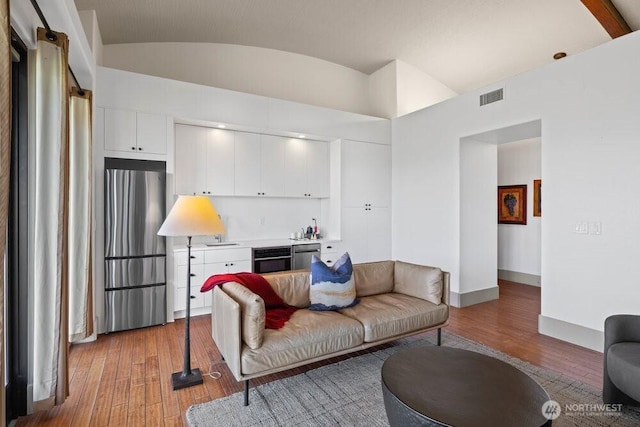344 Silica Rd NW Unit 8, Quincy, WA 98848 - living room featuring wood finished floors, bar, and lofted ceiling