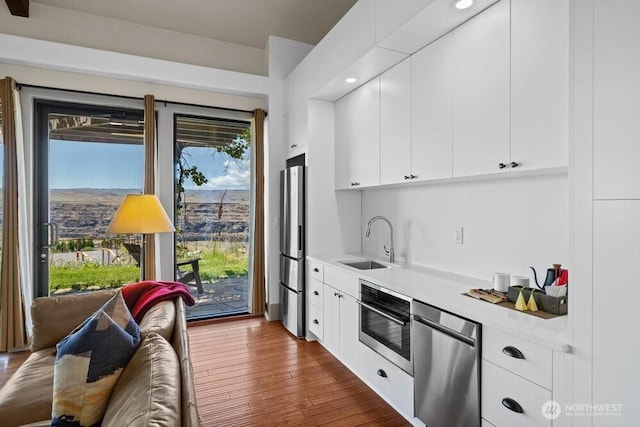 344 Silica Rd NW Unit 8, Quincy, WA 98848 - kitchen featuring stainless steel appliances, light countertops, wood finished floors, healthy amount of natural light, and recessed lighting