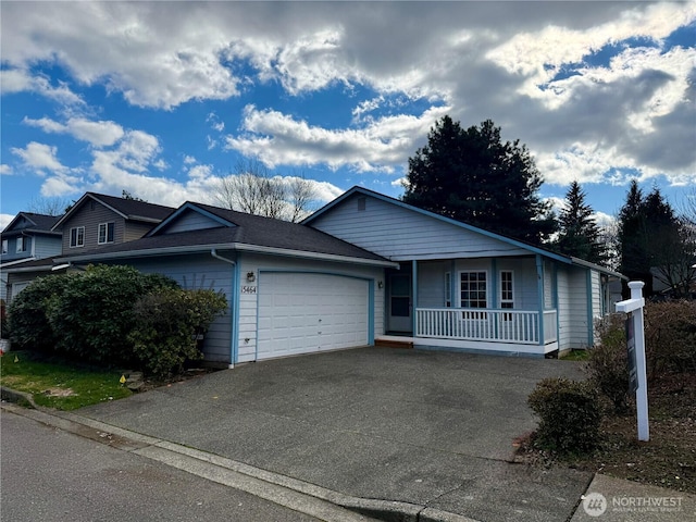 ranch-style house with an attached garage, covered porch, and aphalt driveway