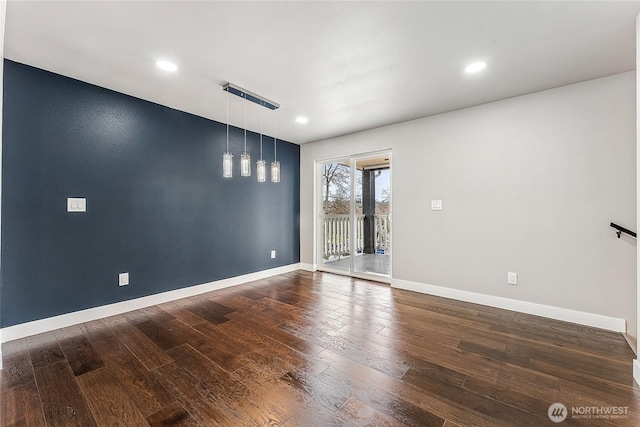 empty room featuring recessed lighting, baseboards, and wood finished floors