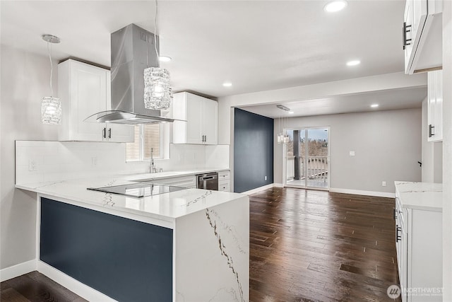 kitchen featuring a peninsula, light stone countertops, white cabinetry, and island range hood