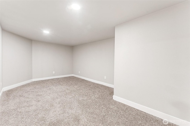 carpeted empty room featuring recessed lighting and baseboards