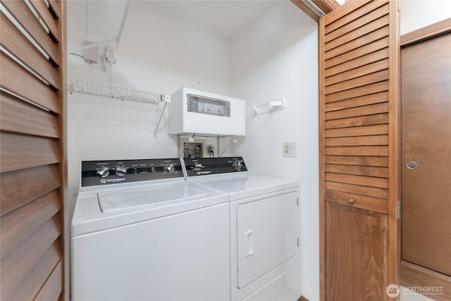 washroom featuring laundry area and washing machine and clothes dryer