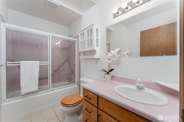 full bath featuring enclosed tub / shower combo, toilet, visible vents, vanity, and tile patterned floors