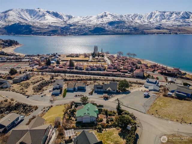 drone / aerial view featuring a residential view and a water and mountain view