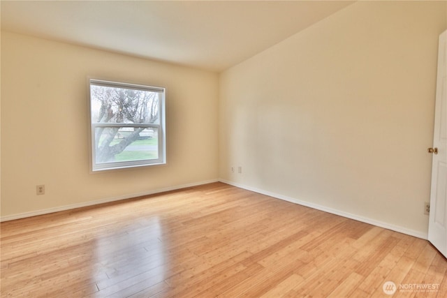 unfurnished room with baseboards and light wood finished floors