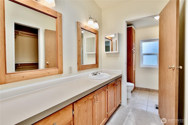 bathroom featuring tile patterned floors, toilet, and vanity