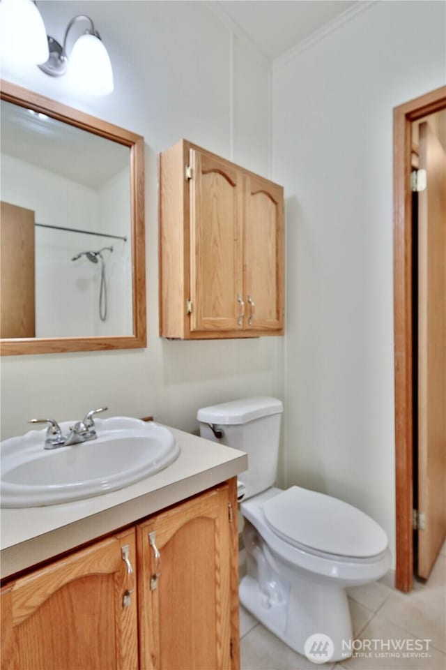 bathroom with vanity, tile patterned floors, toilet, and crown molding