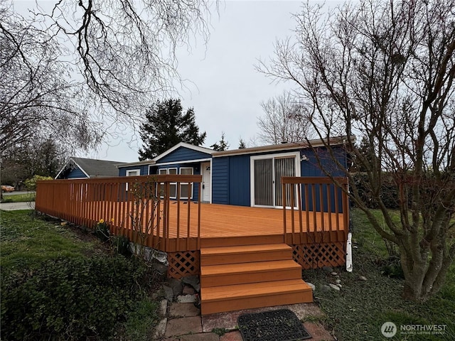 back of property featuring a wooden deck