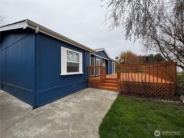 view of side of property featuring a wooden deck